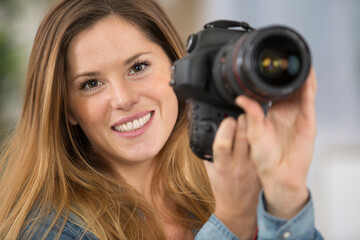 attractive female photographer holding camera