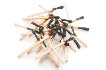 Heap of burnt matchsticks close up on white background