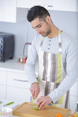 young handsome chef making fruit tarts