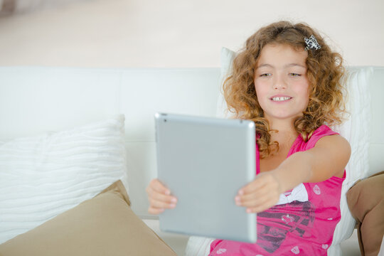 a little girl on tablet