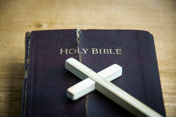 Top view of Holy Bible with wooden cross. Christianity and religious concept