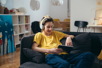 teenager using digital tablet at home