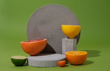 set of citrus fruits on concrete shapes with copy space