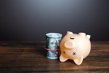 Dead pig piggy bank with money. Financial crisis, depletion of savings and bankruptcy. Default,...
