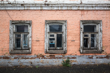Windows of an old brick building, a fragment of the facade. Russia, city of Orenburg