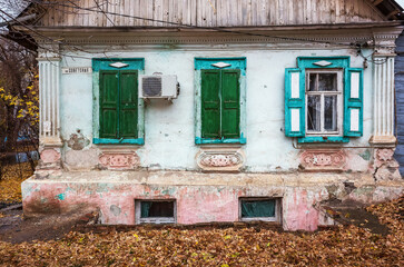 Facade of an old house with a basement floor, autumn. Russia, city of Orenburg
