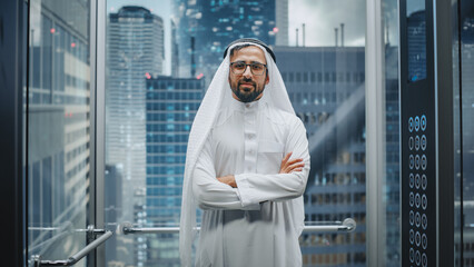 Portrait of a Successful Happy Muslim Businessman in Traditional White Kandura Wearing Glasses...