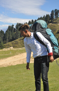A male tourist with parachute backpack in the mountain 