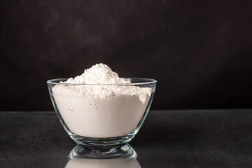 flour isolated on black background