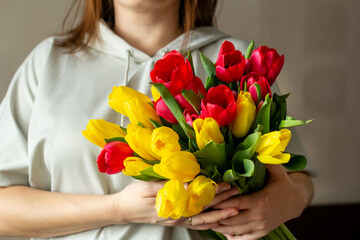 woman holding bouquet of tulips