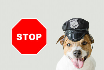 Police dog and stop sign on solid color background. Concept of public ban, restrictions and...