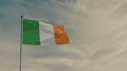 flag of Ireland in the wind against the backdrop of a dramatic sunset sky.
