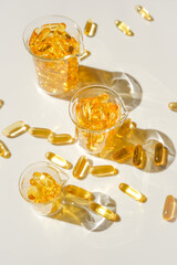 Fish oil gelatin capsules in laboratory transparent flasks .Healthy eating and food...