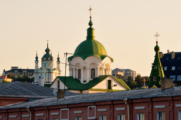 Fototapeta na wymiar Domes of the churches of the evening Podil in Kyiv