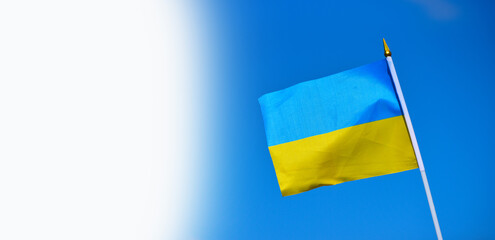 Close-up flag of Ukraine on blue sky background,national blue and yellow flag photo, patriot of Ukraine sign with white space for text