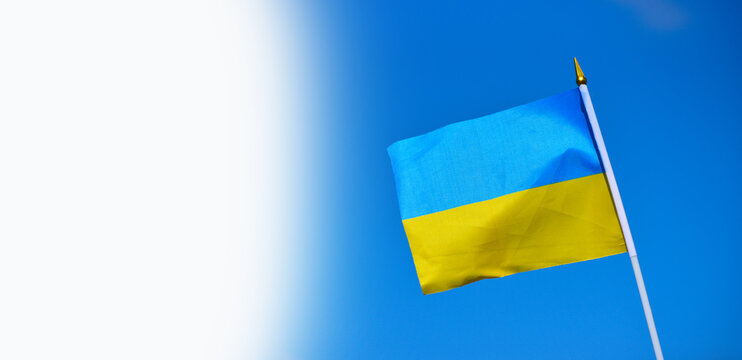 Close-up flag of Ukraine on blue sky background,national blue and yellow flag photo, patriot of Ukraine sign with white space for text