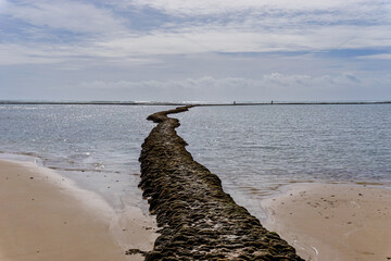 beach and seashore in Rota with the famous Las Corrales walls in the ocean for trapping fish and...
