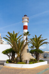 view of the historic lighthouse in the old city center of Rota