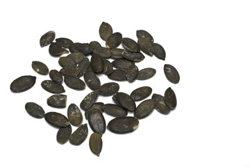 Closeup roasted salted pumpkin seeds white background