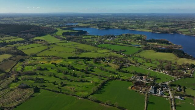 Blessington Lakes, Wicklow, Ireland, March 2022. Drone descends while pulling east over Boystown and Baltyboys Upper towards the Liffey Reservoir facing west with Kildare in the distance.