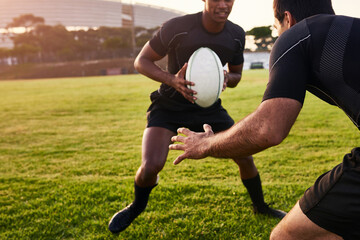 Is he going to tackle me. Cropped shot of two handsome sportsmen playing rugby during a training...