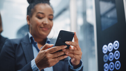 Close up of Black Adult Female Riding Crowded Glass Elevator to Office in Business Center. Successful African American Manager Using Smartphone, Write Message, Check Social Media and Emails in a Lift.