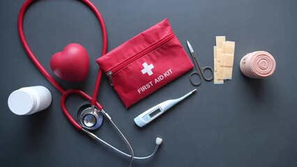 top view of first aid kit and medicine on black 