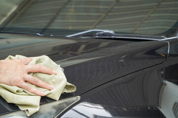 hand wipes black car with chamois cloth Car wash or car detailing and car care
