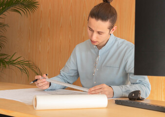 Portrait of young bussinesman architecture drafting in tracing paper