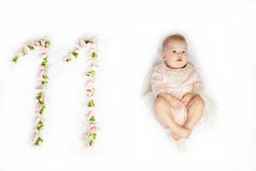 11-month-old baby girl. Baby milestone eleven months. Eleven-month-old baby