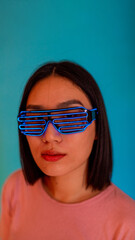 Young woman wearing futuristic metaverse sci-fi led glasses