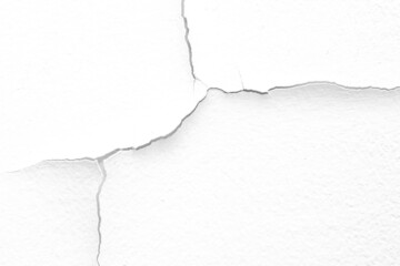 The white concrete wall is cracked, the paper is cracked