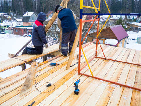 construction of a house in the village.workers make a roof in a private house