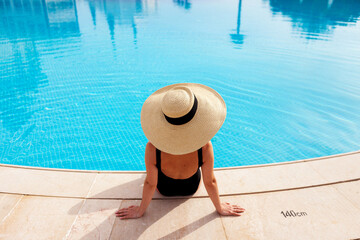 Beautiful woman sunbathing by the pool top view horizontal. Summer background. Poster, mock up for...
