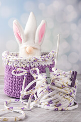 a knitted basket made of knitted yarn and a dwarf with rabbit ears. workshop of needlework and...