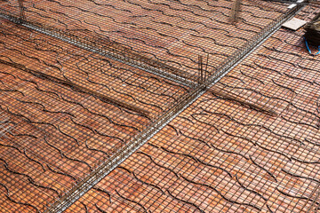 reinforcement steel over wooden planks at a construction site