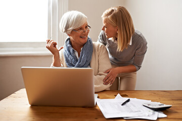 Were done and youre firmly in the black. Cropped view of a senior woman receiving help with her...