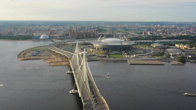 Aerial around view of cable-stayed bridge and new stadium in St.Petersburg during sunset, 4k