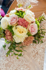 March 2022, bride holds bouquet of flowers in hand