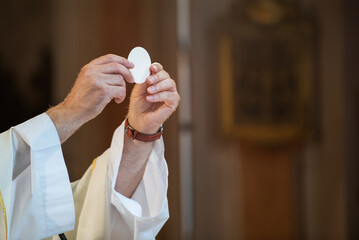 March 2022, Holy host in the hands of the priest on the altar during the celebration of the mass...