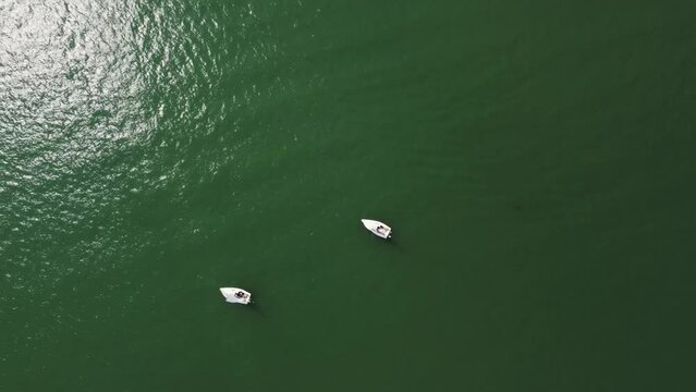 Aerial drone view of sailing boat on a river.