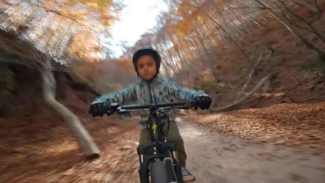 Front view father and son riding MTB  mountain bicycles on a mountain bike trail forest, during fall, family fun sport activities, family weekend 