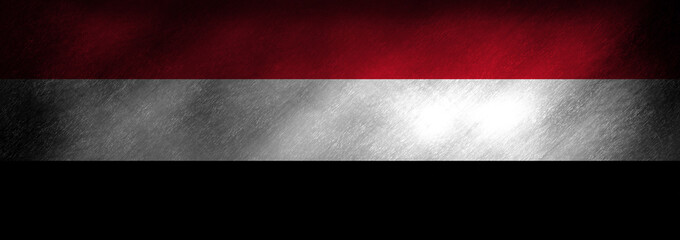 The flag of Yemen on a grunge background