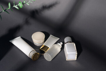 moisturizing cream bottle over black background studio, packing and skincare beauty concept