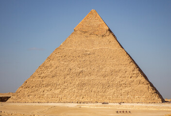Fototapeta na wymiar Pyramid Khafre with row of walking camels Giza, Cairo Egypt