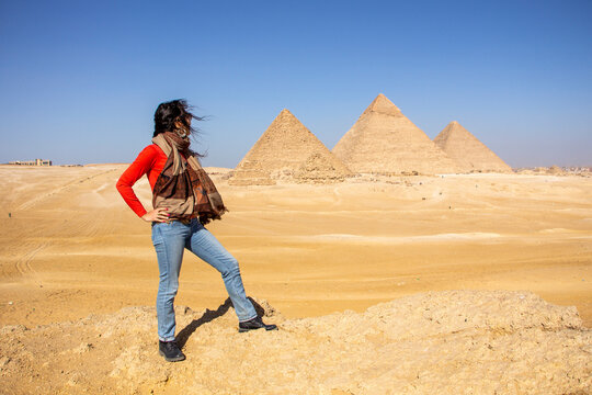 Woman looking at the panoramic view of the pyramids,Giza, Cairo, Egypt