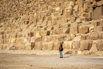 Woman at the base of the Cheops, Giza, Cairo, Egypt
