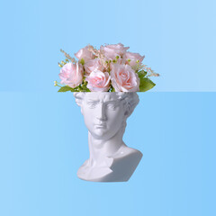 White Roman bust with pink roses in a composite im age