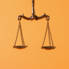 Pendulum scales over an orange background with copyspace