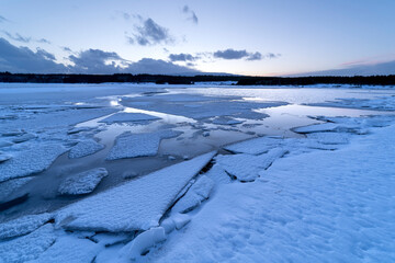 Frozen river during sunset